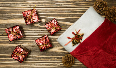 Gifts and santa's boot on wooden background. Flat lay