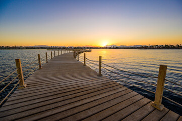 Fototapeta na wymiar Wooden Pier on Red Sea in Hurghada at sunset, View of the promenade boardwalk - Egypt, Africa