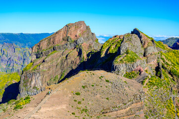 Beautiful hiking trail from Pico do Arieiro to Pico Ruivo, Madeira island. Footpath PR1 - Vereda do Areeiro. On summy summer day above the clouds. Portugal.