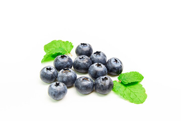 Group of blueberries together with some mint leaves on a white background
