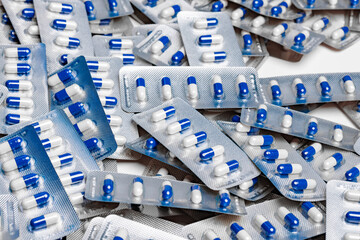 Blue and white capsule pills in blister packs