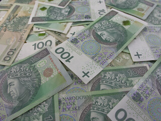Fototapeta na wymiar Polish Currency 100 Zloty Bills Cash on a Table