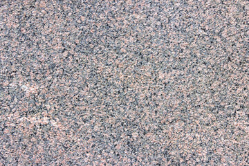 Texture of motley granite gray and red slab.