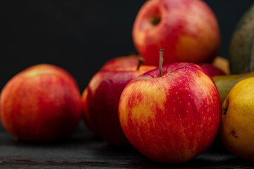 Pile of red apples on black background