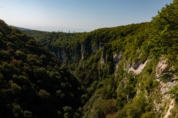 deep canyon between green mountains