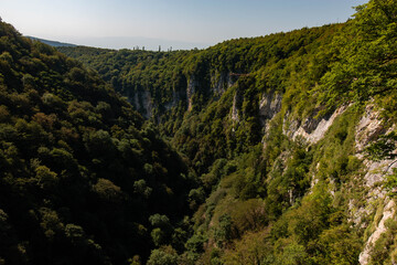 deep canyon between green mountains