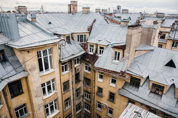 Fototapeta na wymiar Well courtyard of St. Petersburg, top view. Tin roofs of houses in old city.