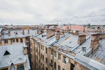 Fototapeta premium Iron roofs of houses in old city. Top view of winter St. Petersburg.