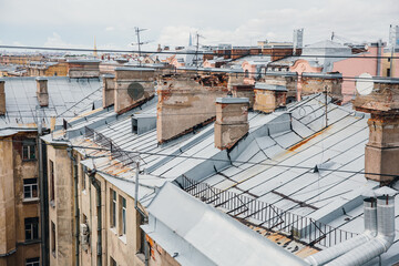 Fototapeta premium City roofs of old district of European city in rainy weather.