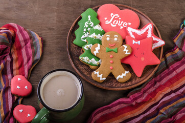 Mug with cocoa and different Christmas gingerbread cookies on a dark background