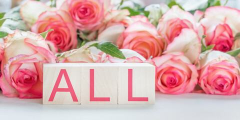 all text with red letters on wooden blocks bouquet of roses background