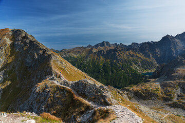 Landscapes with a tourist on a background of mountains and lakes with evening lighting