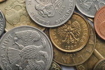 coins of different colors and sizes are scattered on the table, close-up