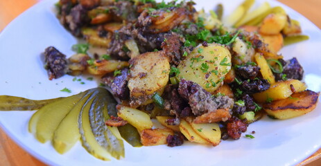 Bratkartoffeln mit Blutwurst, Gurken und Petersilie