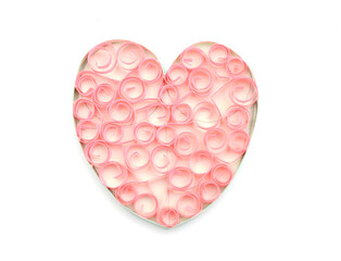 A pink quilling paper heart on white