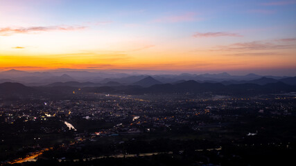 City surrounded by mountains at sunset, Phu Bo Bit view point, Loei, Thailand, Oct 26, 2020.