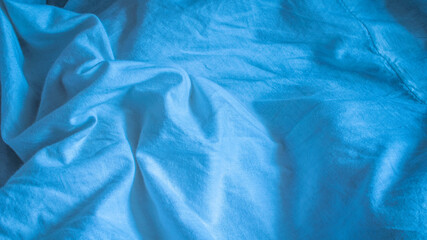 pleated blue cotton material. texture or background