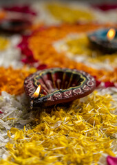 
Flower petal rangoli for Diwali with diwali diya selective focus
