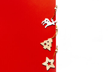 Wooden Christmas toys on a red and white background.Christmas or new year background with space for text.