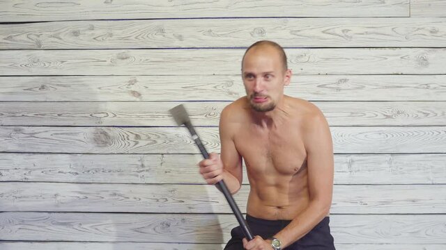 aggressive maniac killer with an ax indoors