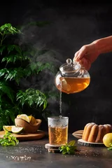 Foto op Plexiglas Woman hand pourung a hot black tea © nolonely