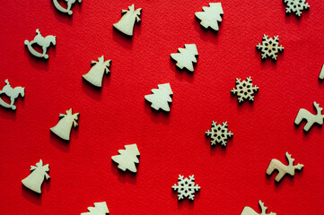 Wooden figures on a red background.Christmas or new year background.