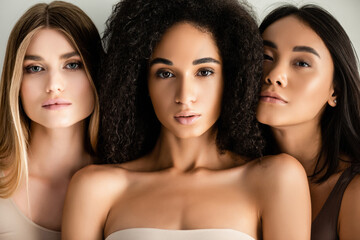 close up of young interracial models looking at camera isolated on white - obrazy, fototapety, plakaty