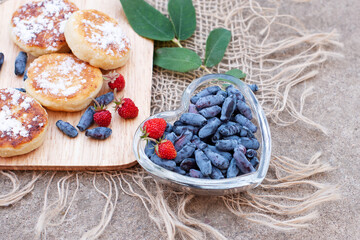 honeysuckle berries on a concrete background.