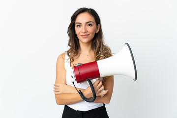 Young caucasian woman isolated on white background holding a megaphone and smiling