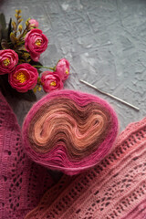 Crochet background flatlay. Crochet hook and scarf on a concrete background