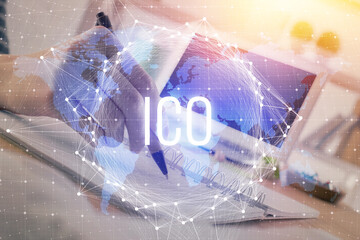 Cryptocurrency hologram, bitcoin, ico theme over hands taking notes background. Concept of...