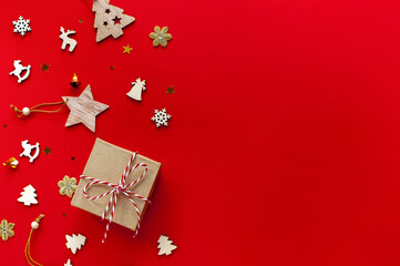 Wooden Christmas toys with a gift on a red background.Christmas and new year background.
