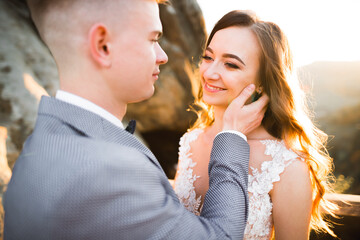 Gorgeous happy couple standing close to each other and looking in eyes