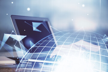 Multi exposure of world map hologram with man working on computer on background. Concept of worldwideweb.