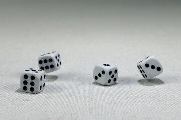  White playing dice cubes in motion on the white canvass surface