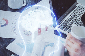 Businessman with computer background with brain theme hologram. Concept of brainstorm. Multi...