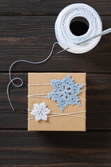 Idea gifts wrapping of the Christmas gift and decoration with knitted snowflakes.