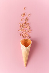 Pile of capsules Omega 3 on pink background. Close up, top view, high resolution product.