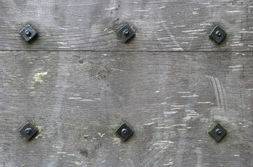 Close Up of Old Textured Wooden Beam with Steel Bolts 