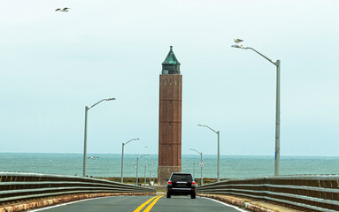 Driviing down the Robert Moses bridge looking at water tower and ocean.