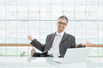 Happy businessman in modern business office