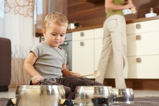 Little boy playing cooking at home