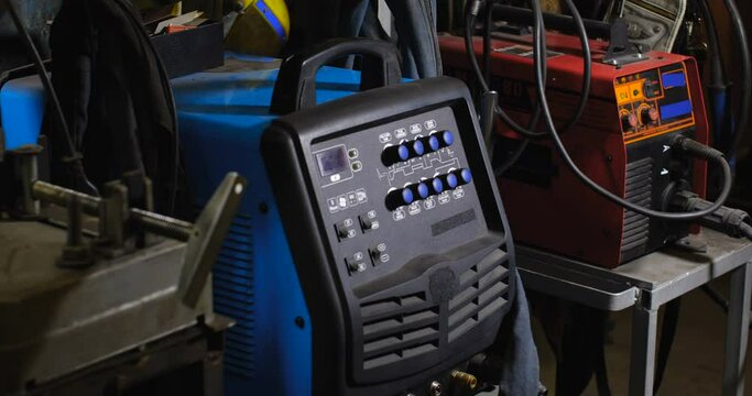 Work in the workshop for the manufacture of tin products. Tracking shot near welding machine control panel.  4K 50 fps slow motion