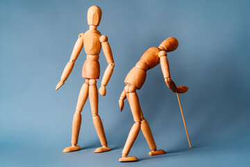 a young and healthy man walks by an elderly man with a walking stick. The concept of approaching old age.