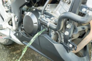 Close up of pouring coolant from Motorcycles engine.