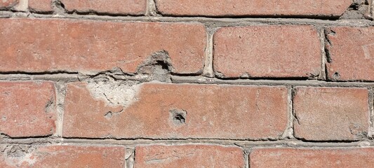 Background of an old brick wall with chips and defects. Vintage.