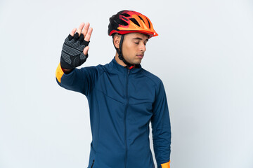 Young cyclist Brazilian man isolated on white background making stop gesture and disappointed