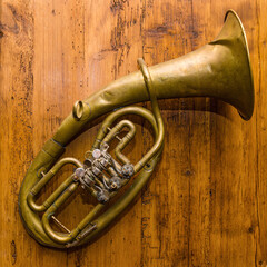 old musical instrument trumpet on a wooden background