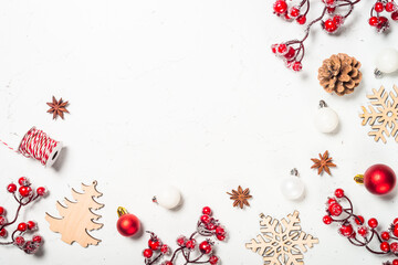 Christmas composition with red decorations at white table.