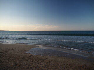 Fototapeta na wymiar Sandy beach at sunset. Peace of mind on the beach